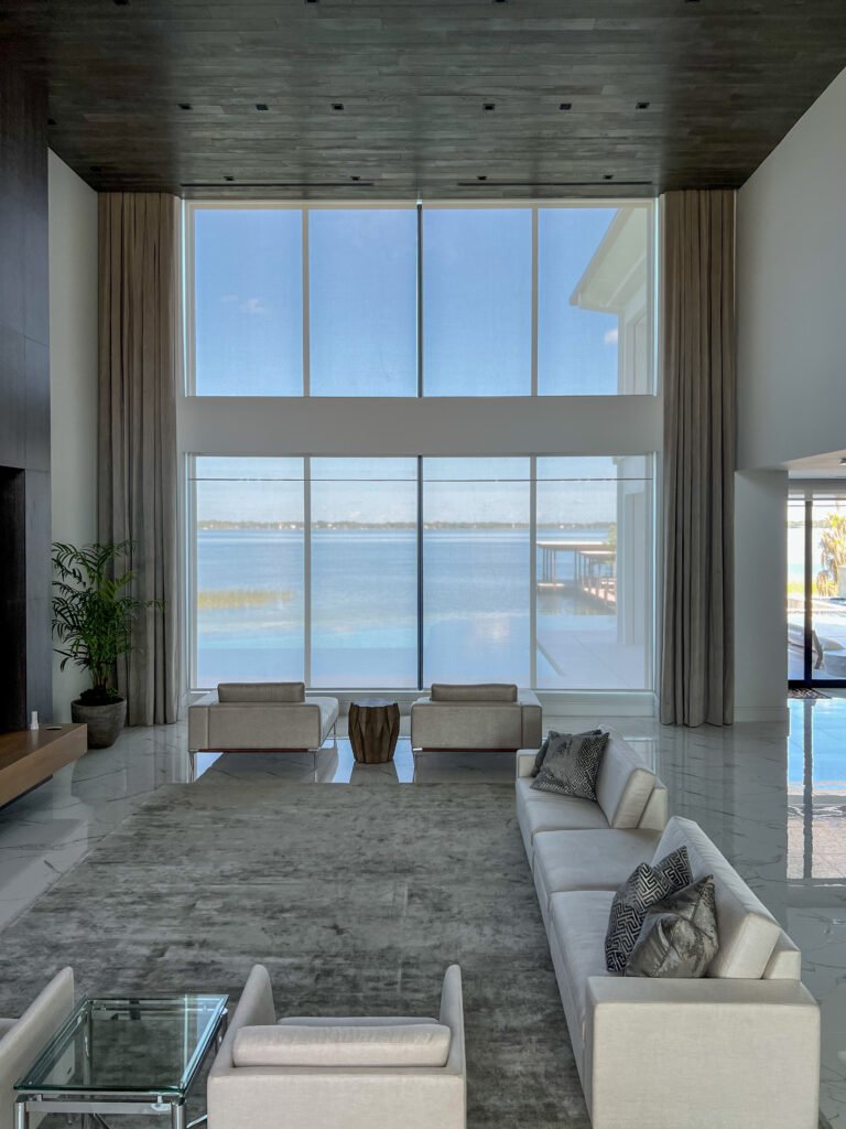 roller shades on large windows providing light control without visual weight